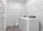 Thumbnail 7 of 46 - the laundry room has two washes and a dryer in it