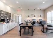 Thumbnail 18 of 46 - an open kitchen and dining area with a table and chairs and a kitchen counter top