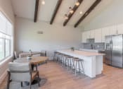 Thumbnail 17 of 46 - a kitchen with a large island and a table with chairs