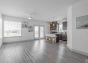 Thumbnail 2 of 46 - a living room and kitchen with wood flooring and a large window