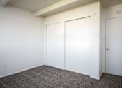 Thumbnail 10 of 26 - A room with a carpeted floor and white walls.