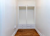 Thumbnail 45 of 52 - A white closet with a white door and two white drawers.