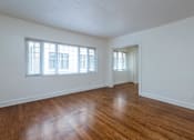Thumbnail 33 of 52 - A room with wooden floors and two windows.