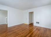 Thumbnail 40 of 52 - A room with wooden floors and white walls.