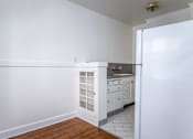 Thumbnail 48 of 52 - A kitchen with white cabinets and a white refrigerator.