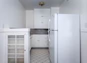 Thumbnail 42 of 52 - A kitchen with white cabinets and a white refrigerator.