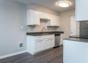 Thumbnail 14 of 27 - Vantage at Hillsdale | #3 Kitchen with White Cabinetry and Black & Stainless Steel Appliances