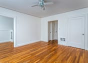 Thumbnail 22 of 52 - A room with wooden floors and white walls.