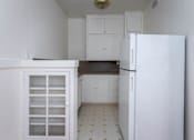 Thumbnail 27 of 52 - A kitchen with white cabinets and a white refrigerator.