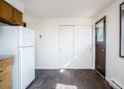 Thumbnail 16 of 24 - an empty kitchen with a white refrigerator and a white door