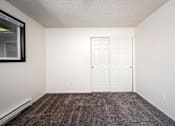 Thumbnail 20 of 24 - an empty room with carpet and a door