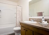 Thumbnail 5 of 24 - a bathroom with a sink and a toilet and a shower