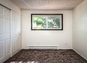 Thumbnail 21 of 24 - an empty room with carpet and a window