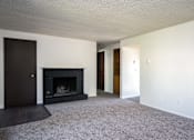 Thumbnail 18 of 24 - an empty living room with a fireplace and white walls