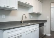 Thumbnail 21 of 27 - Vantage at Hillsdale | #36 Kitchen with White Cabinetry and Black & Stainless Steel Appliances