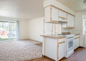Thumbnail 14 of 26 - A kitchen with white appliances and cabinets.