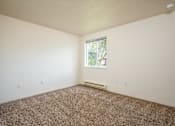 Thumbnail 12 of 26 - A room with a window and a carpeted floor.