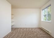 Thumbnail 21 of 26 - A room with a carpeted floor and a window.