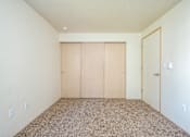 Thumbnail 20 of 26 - A room with a carpeted floor and a white wall.