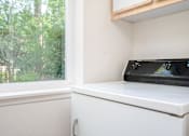 Thumbnail 23 of 26 - A black microwave oven is on a white countertop.