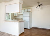 Thumbnail 9 of 26 - A kitchen with white cabinets and a white refrigerator.