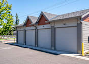 Thumbnail 5 of 13 - A two-car garage with a brown roof and grey walls.