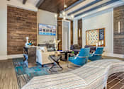Thumbnail 8 of 11 - A living room with a white couch and blue chairs at Crabtree Lakeside Apartments, Raleigh, NC