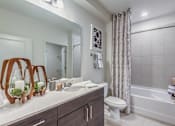Thumbnail 4 of 11 - A bathroom with a white sink, toilet, and bathtub at Crabtree Lakeside Apartments, Raleigh, North Carolina