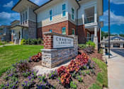 Thumbnail 11 of 11 - Crabtree Lakeside Apartments is a residential complex with a well-maintained garden in front at Crabtree Lakeside Apartments, Raleigh, NC