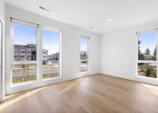Thumbnail 15 of 45 - a living room with large windows and a wooden floor
