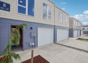 Thumbnail 25 of 45 - a blue and white building with two garage doors