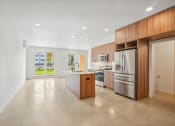 Thumbnail 37 of 45 - a large kitchen with stainless steel appliances and wooden cabinets