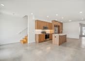 Thumbnail 32 of 45 - a kitchen with wooden cabinets and a counter top in a house
