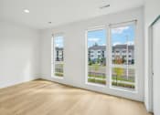 Thumbnail 38 of 45 - an empty living room with a row of windows