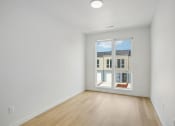 Thumbnail 42 of 45 - a living room with white walls and a window