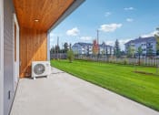Thumbnail 26 of 45 - the patio of a home with a yard and an a/c on it