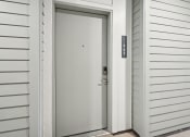 Thumbnail 36 of 45 - the front door of a house with a white door with a silver handle