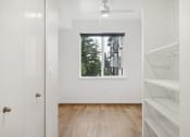 Thumbnail 45 of 45 - an empty room with a window and a closet