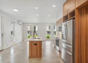 Thumbnail 44 of 45 - a large kitchen with stainless steel appliances and wooden cabinets