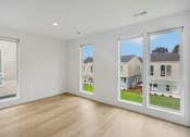 Thumbnail 43 of 45 - a living room with large windows and a wooden floor