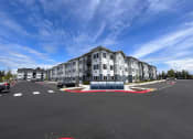 Thumbnail 1 of 45 - a building with a parking lot in front of it