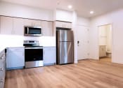 Thumbnail 5 of 45 - a kitchen with a refrigerator freezer and a stove top oven