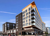 Thumbnail 1 of 36 - Southwest corner view of glass balconies and windows