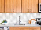 Thumbnail 16 of 36 - Tile backsplash and walnut finish cabinets
