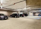 Thumbnail 23 of 36 - Covered parking garage with assigned car parking
