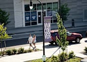 Thumbnail 28 of 36 - Couple walking on boardwalk on Waterfront Way
