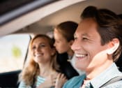 Thumbnail 16 of 45 - Family laughing while riding in a car