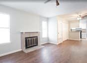 Thumbnail 8 of 14 - A living room with a fireplace and wood flooring  at Callaghan Heights, TX, 78228