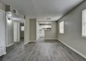 Thumbnail 8 of 20 - an empty living room and kitchen in a new home at The Crossings at Montrose Apartments, Texas, 78223