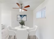 Thumbnail 4 of 41 - a dining room with a table and chairs and a ceiling fan